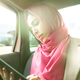 woman in headscarf working in a taxi